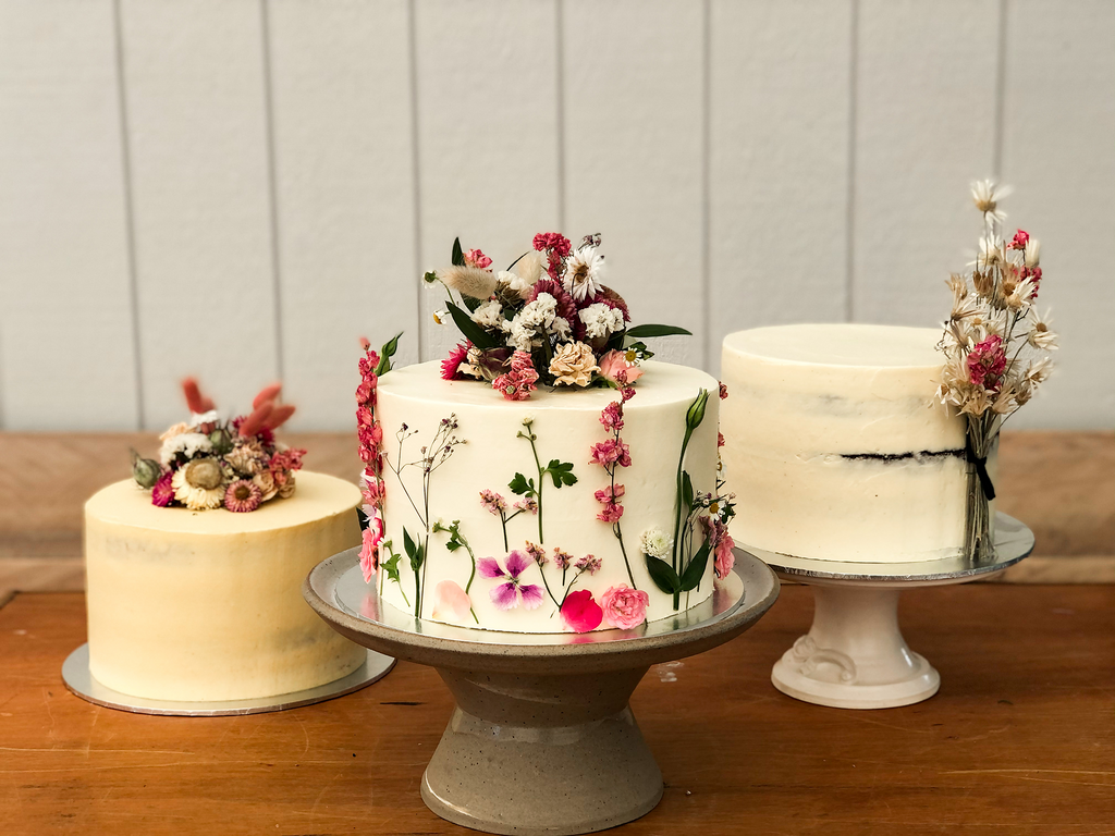 Three buttercream wedding cakes with dried flowers at Ataahua